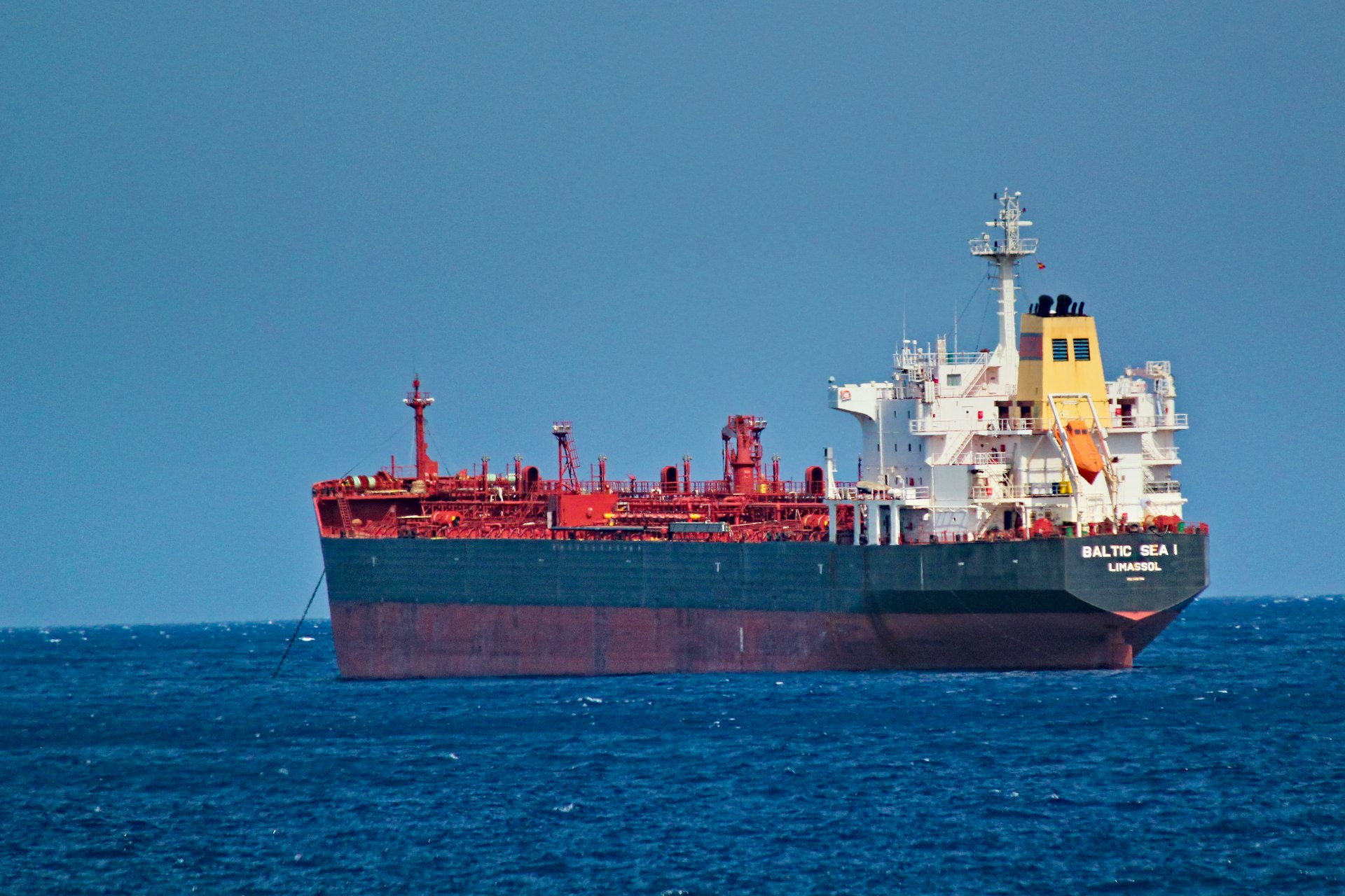red and white cargo ship on sea during daytime